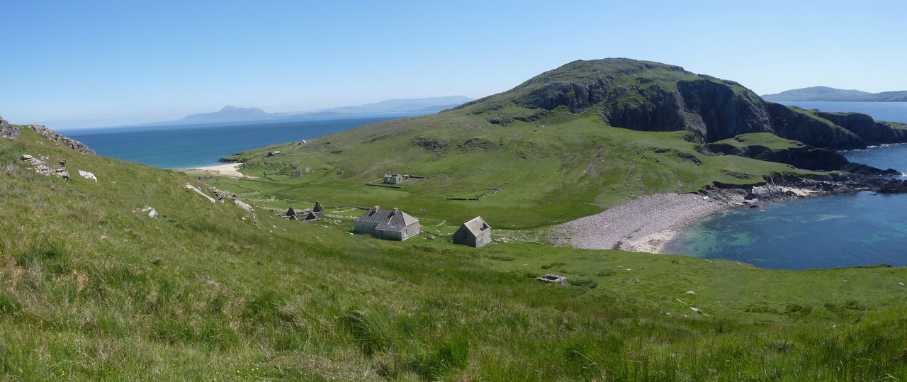 Achillbeg looking south to some of the island houses and the school on narrow waist of the island with its two beaches and, beyond, the southern hill on the other side of which is the lighthouse.